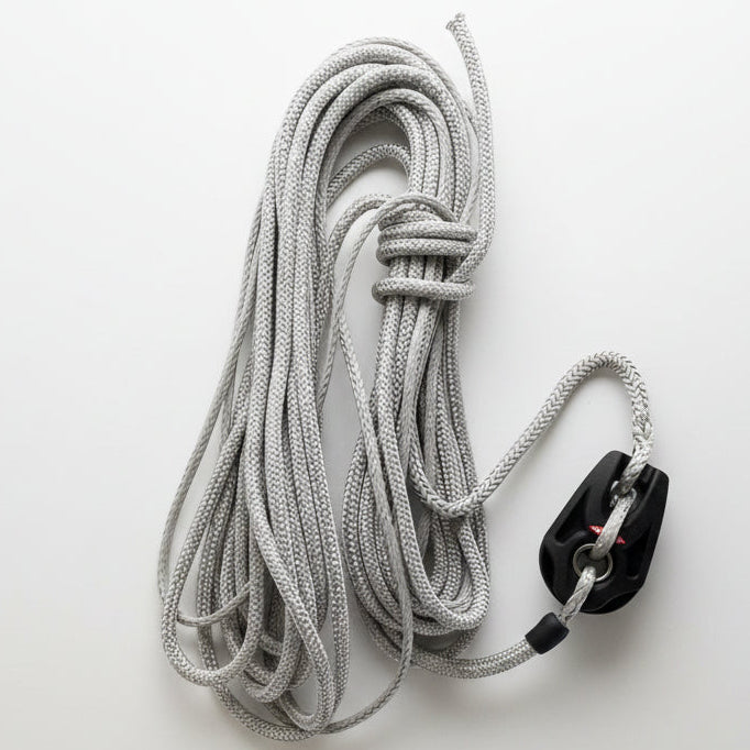 Coiled gray rope with a black block on a white background