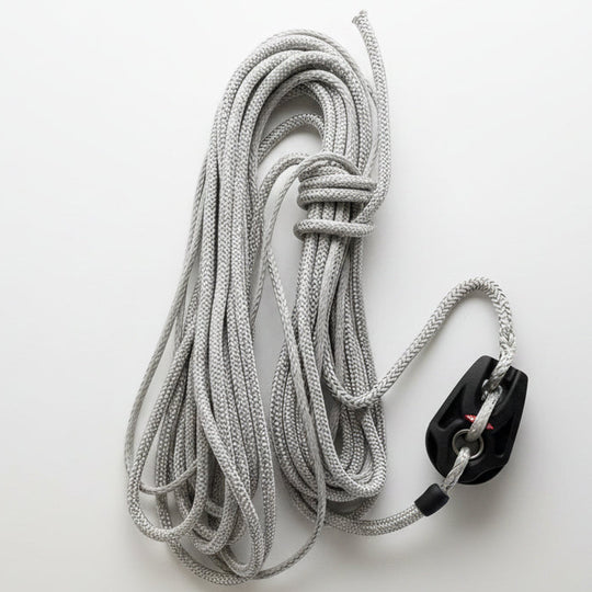 Coiled gray rope with a black block on a white background
